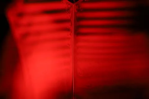 Red reflections of liquid in macro, red geometric shapes 写真素材