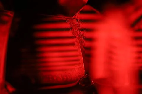 Red reflections of liquid in macro, red geometric shapes Stock Photos