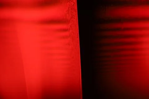 Red reflections of liquid in macro, red geometric shapes Stock Photos