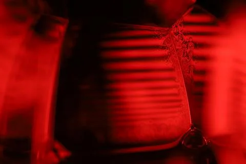 Red reflections of liquid in macro, red geometric shapes Stock Photos