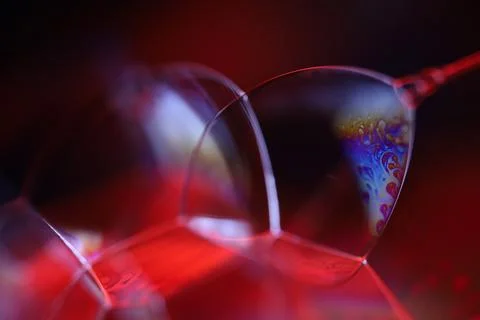 Red reflections of liquid in macro, red surface Stock Photos