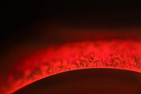 Red reflections of liquid in macro, red surface 写真素材