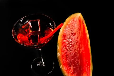 Red refreshing drink on the basis of watermelon on a black background Stock Photos