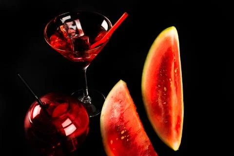 Red refreshing drink on the basis of watermelon on a black background Stock Photos