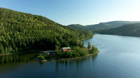 Red remote cabin at the foot of a mountain hills side Stock Footage 236286758