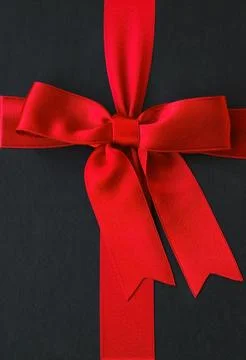 Red ribbon on black surface Stock Photos