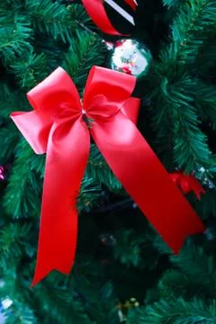 Red ribbon closeup  from christmas tree. Stock Photos