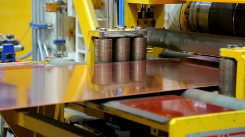 The red ribbon of the copper sheet moves in the machine close-up Stock Footage 103848785
