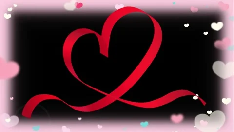 Red ribbon heart shape floating amidst soft pastel bokeh particles against dark Stock Footage 342110482