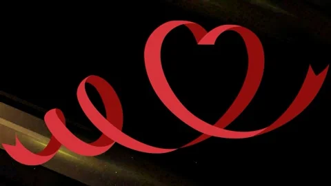 Red ribbon heart shape floating against dark background with golden light Video stock 343552183