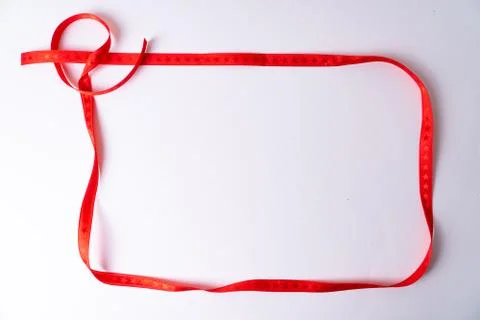 A red ribbon with stars building a frame on white background Stock Photos