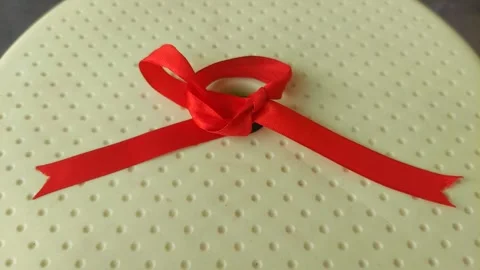 Red Ribbon on Yellow Surface Видео 290169680