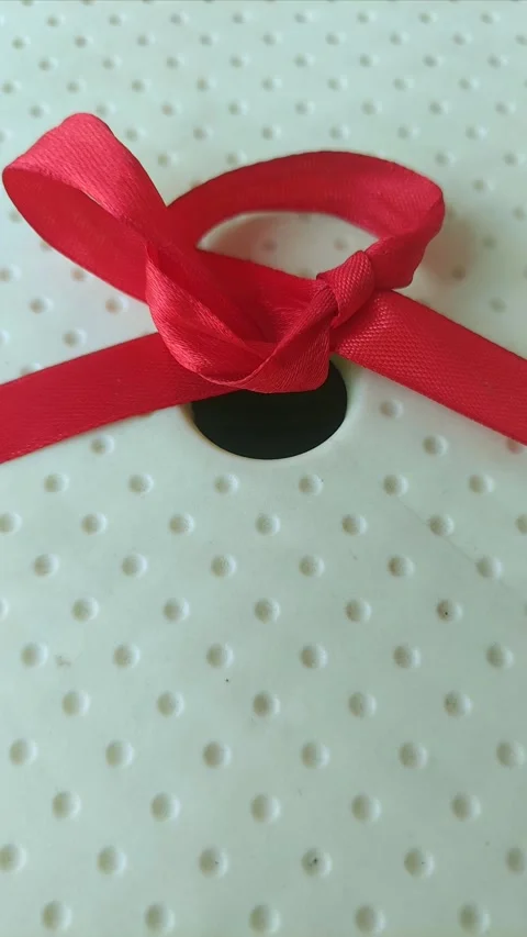 Red Ribbon on Yellow Surface Stock Footage 290169728