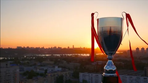 Red ribbons on the wind with winner cup Stock Footage 77074661