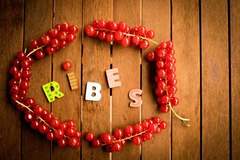 Red ribes on wood table Stock Photos