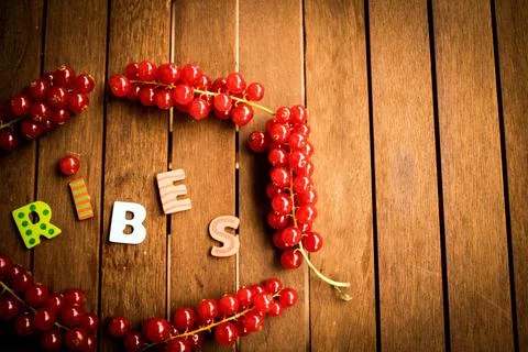 Red ribes on wood table Stock Photos