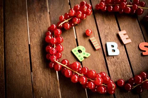 Red ribes on wood table Stock Photos