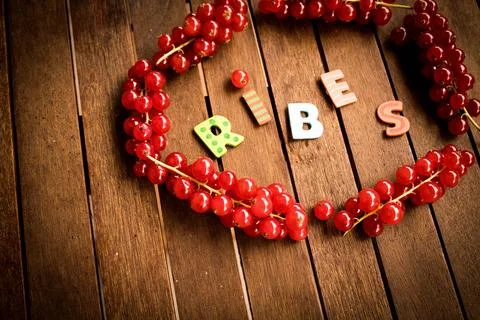 Red ribes on wood table Stock Photos