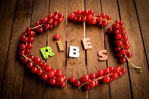 Red ribes on wood table Stock Photos