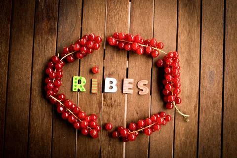 Red ribes on wood table Stock Photos