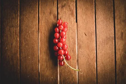 Red ribes on wood table Stock Photos