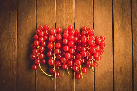 Red ribes on wood table Stock Photos