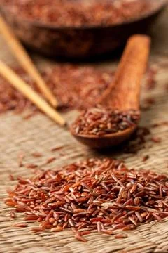 Red rice  on a straw background Stock Photos