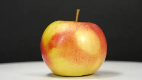 Red ripe apple fast rotates on black background Stock Footage 310737792