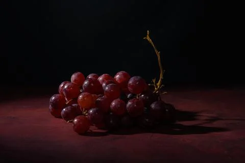 Red, ripe grapes on a rustic table Stock Photos