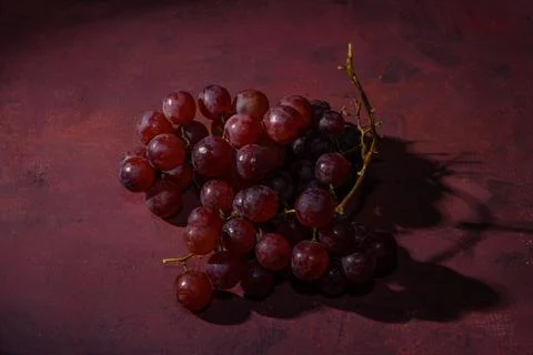 Red, ripe grapes on a rustic table Stock Photos