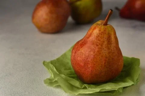 Red ripe pears on a light background. Copy space. Selective focus. Stock Photos