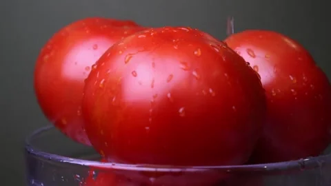 Red ripe tomatoes in a plate close up slow motion Stock Footage 135413892