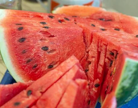 Red ripe watermelon lying on the table closeup Stock Photos