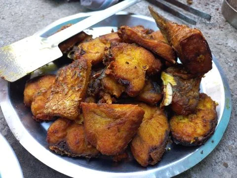 Red roast fish cut into small pieces. Stock Photos
