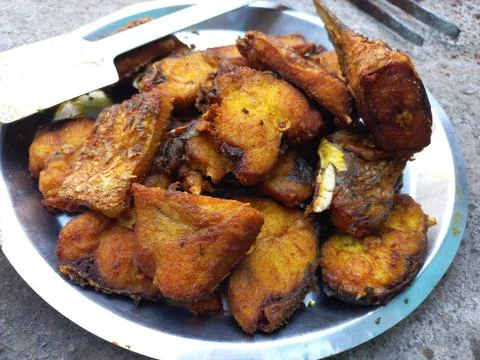 Red roast fish cut into small pieces. Stock Photos