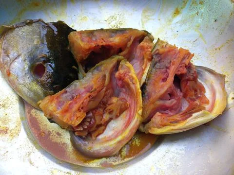 Red roast fish cut into small pieces. Stock Photos