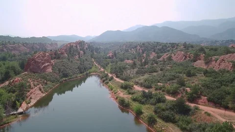 Red Rock Canyon Water Flyover with Mountain Background Stock Footage