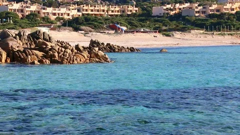 Red rock cliff with beach in the background with audio  Stock Footage 128930338
