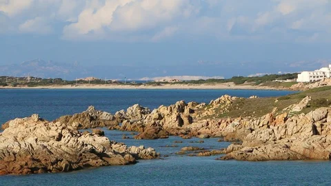 Red rock cliff with beach in the background Stock Footage 128930342