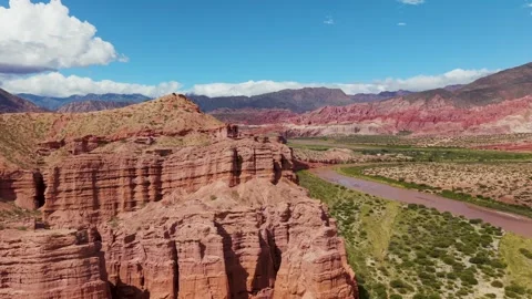 Red rock cliffs and river in desert landscape, Argentina Stock Footage 332284075