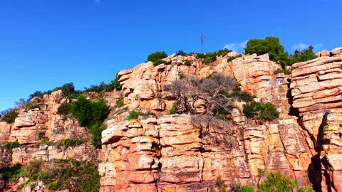 Red rock cliffs with cross and communication towers Stock Footage 334858410