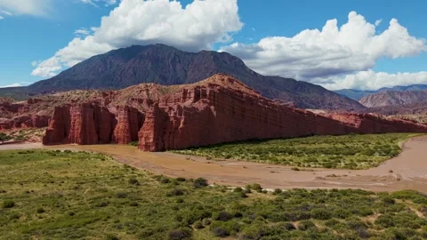Red rock cliffs with mountain and clouds, Salta, Argentina Stock Footage 332284074