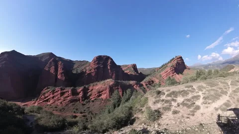 Red rock formations in Jeti-Oguz gorge, Kyrgyzstan, 4K Stock Footage 342030479
