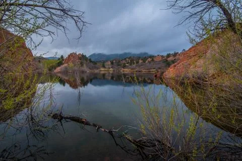 Red rock formations reflected in a lake. Stock Photos