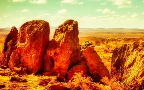 Red Rock Formations Under Dramatic Cloudy Sky in Arid Landscape Stock Photos
