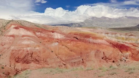 Red rock mountains form a dramatic landscape late in the afternoon Stock Footage 278022262