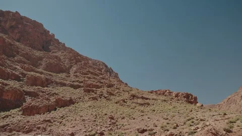 Red Rock Mountainside With Scrub and Layered Cliffs in Morocco Stock Footage 340595936