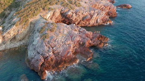 Red rocks and dark blue sea on the shoreline of the Adriatic coast Stock Footage 137555124