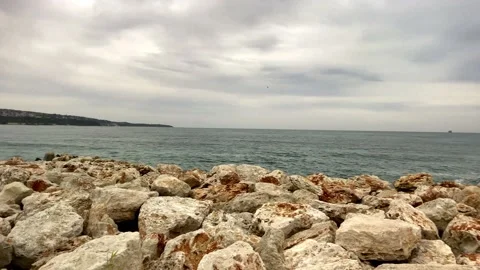 Red Rocks In The Sea And Colored Stones On The Beach. Large Piece Of Rock On Sea Stock Footage 149013556