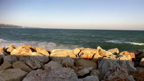 Red Rocks In The Sea And Colored Stones. Surf On Stones. Waves On The Sea Beach. Stock Footage 149693550